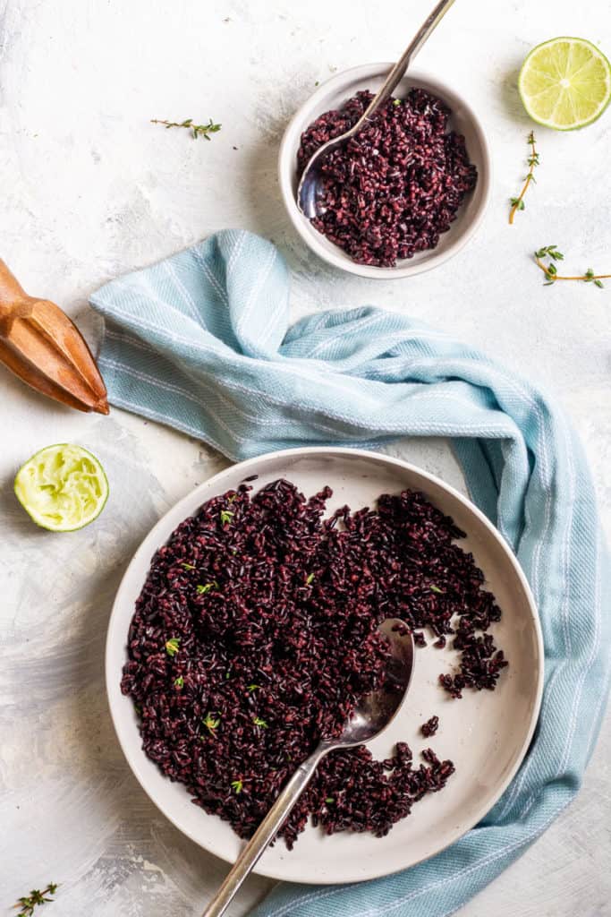 Black rice with lime dressing in a serving dish.