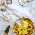 mushroom quiche with a slice cut out