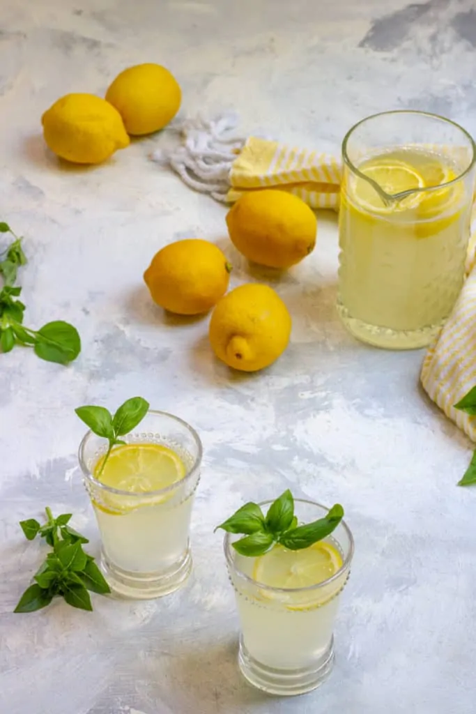basil lemonade in a pitcher + in glasses
