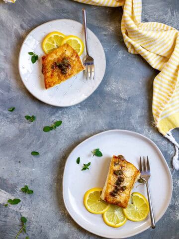 Pan-Seared Halibut with Lemon Caper Sauce on Plates.