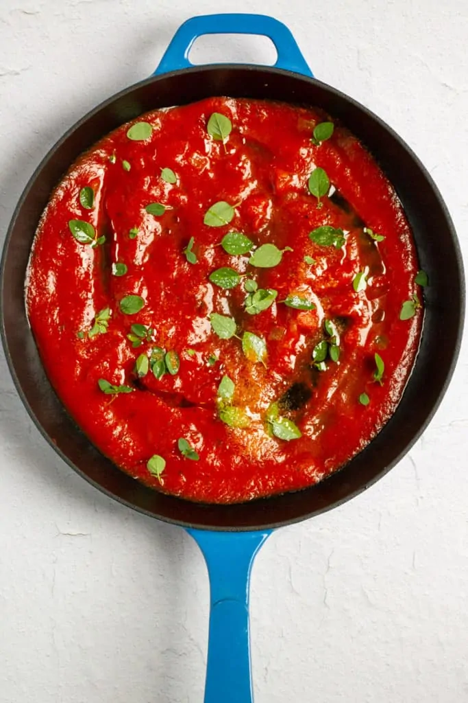Add Tomato Sauce + Fresh Herbs to an Oven-Safe Pan