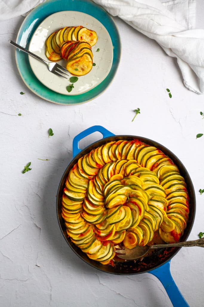baked zucchini + squash in a serving dish + on a plate