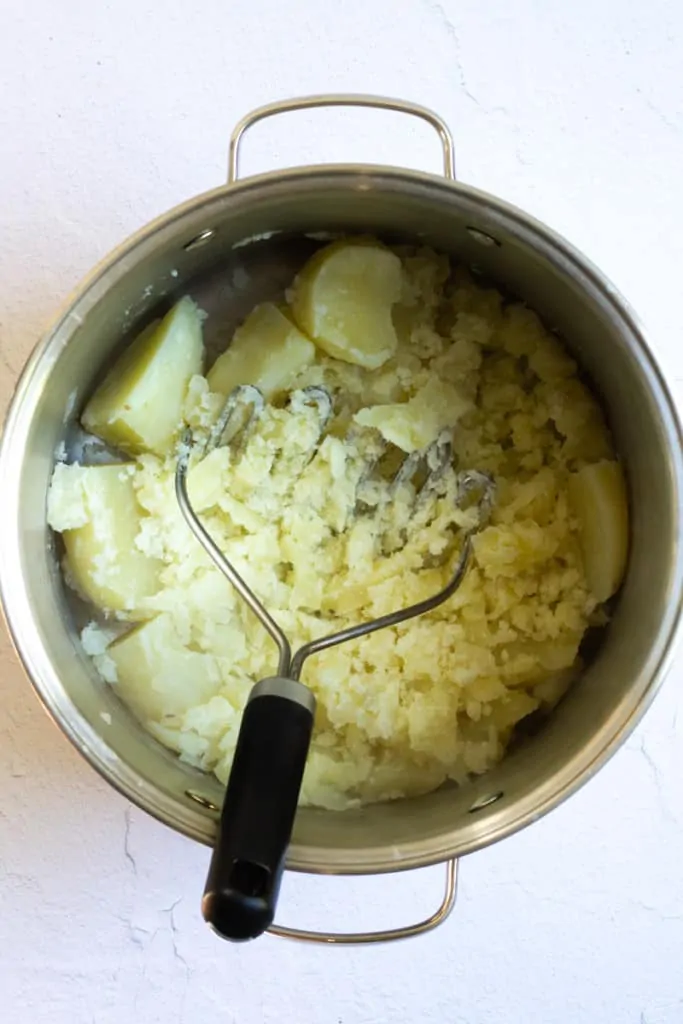 Mash with a Potato Masher or Ricer.