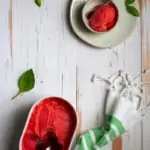 Strawberry basil sorbet in a container + bowl
