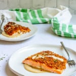 Baked mustard salmon on a plate with tahini dressing