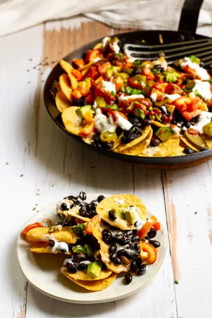 black bean nachos in a pan + plate
