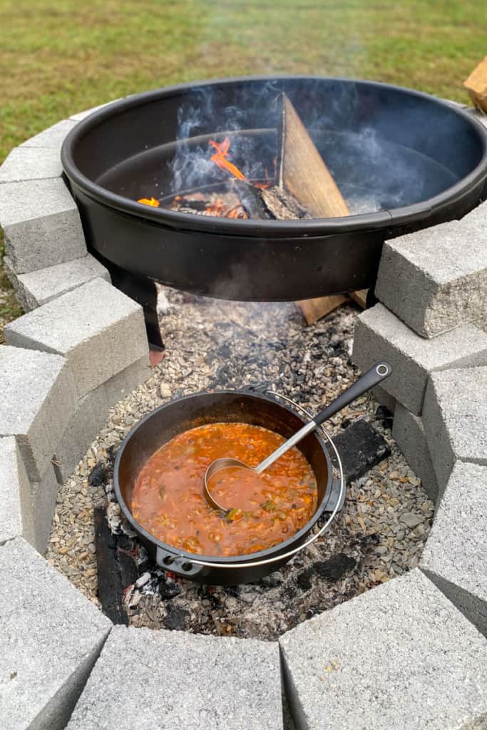 Chili cooking in a camping kitchen gear dutch oven.