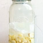 Top Garlic with Water + Parchment Paper
