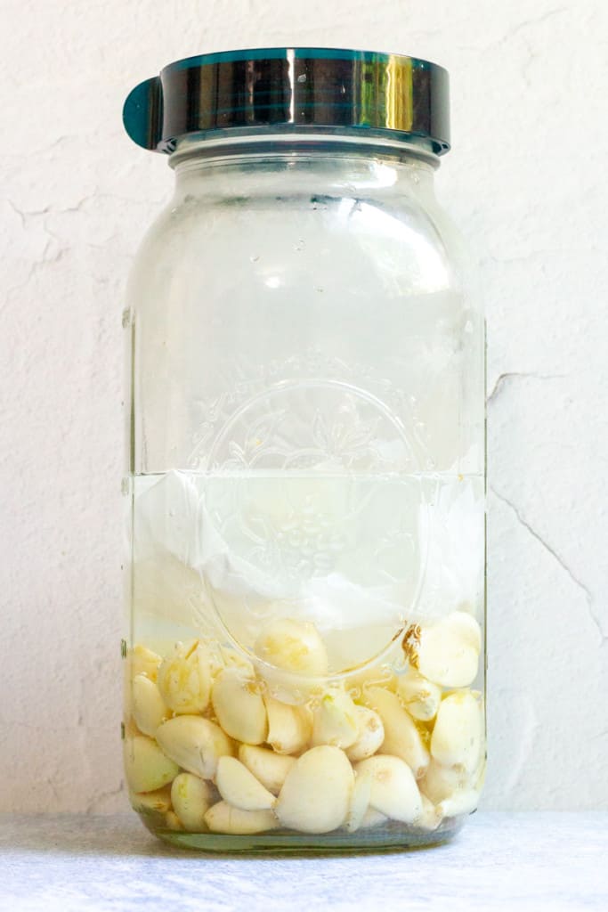 Top Garlic with Water + Parchment Paper