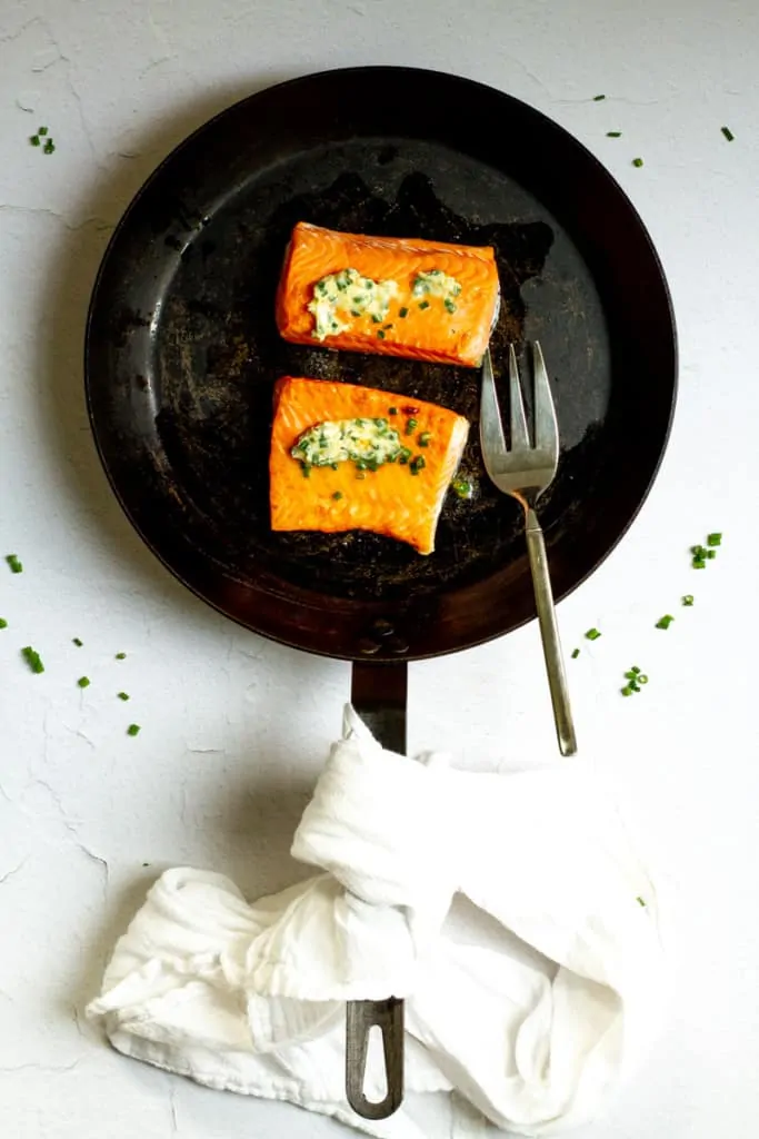 herb butter salmon in the pan after cooking
