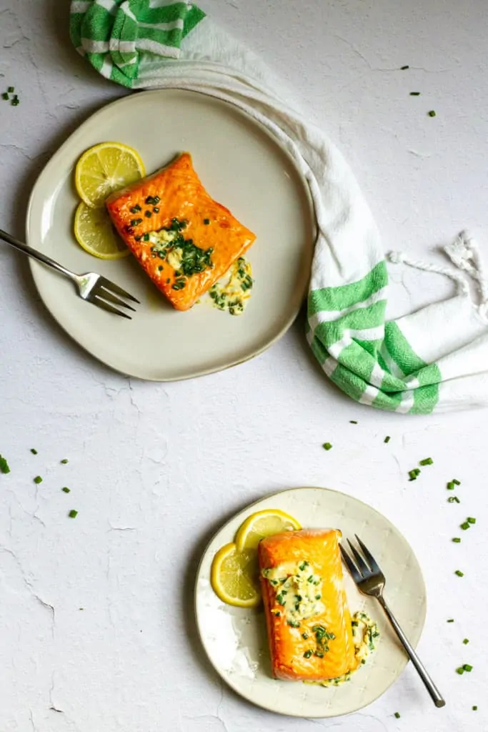 herb butter salmon on plates
