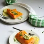 herb butter salmon on plates