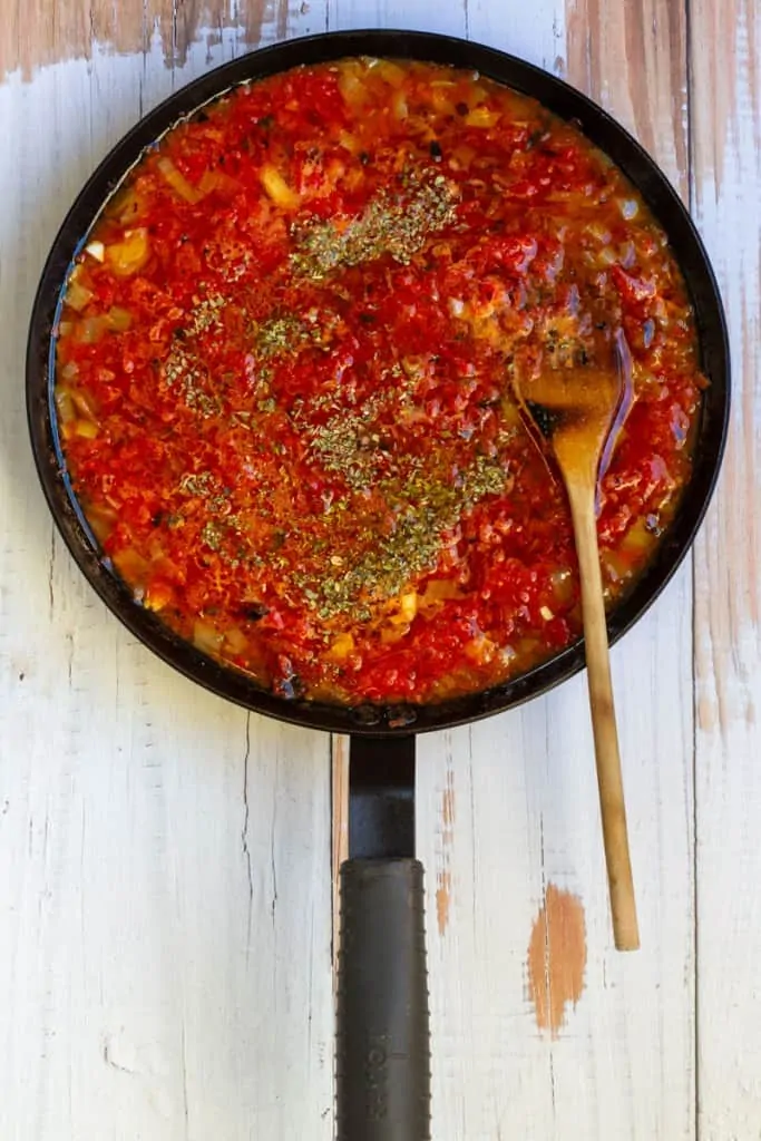 Add Tomatoes, Water + Oregano.