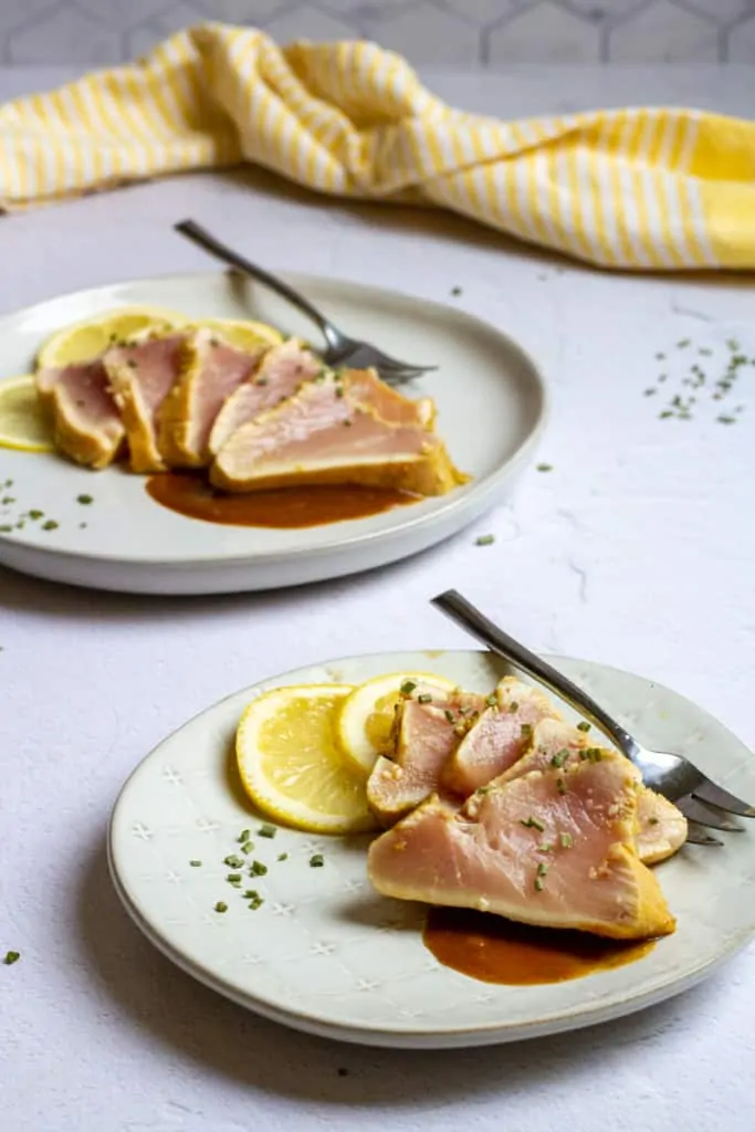 Seared albacore tuna slices on plates