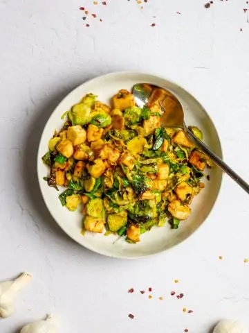 chili garlic tofu with brussels sprouts in a bowl