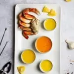 crab butter sauce on a platter with crab legs