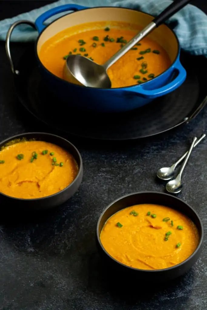 roasted kabocha squash soup in a Dutch oven and bowls
