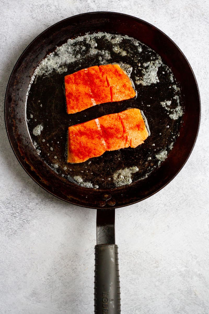 Salmon cooking Skin-Side Down in Pan.