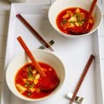Vegan kimchi soup in bowls on a serving tray
