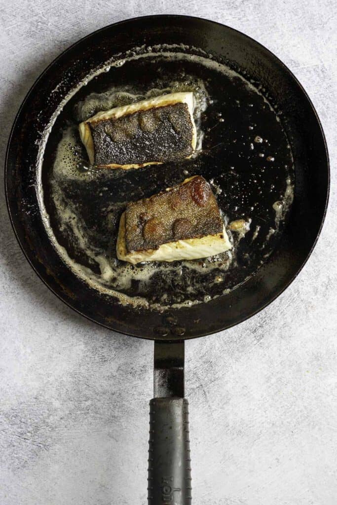 sablefish fillets in a pan.