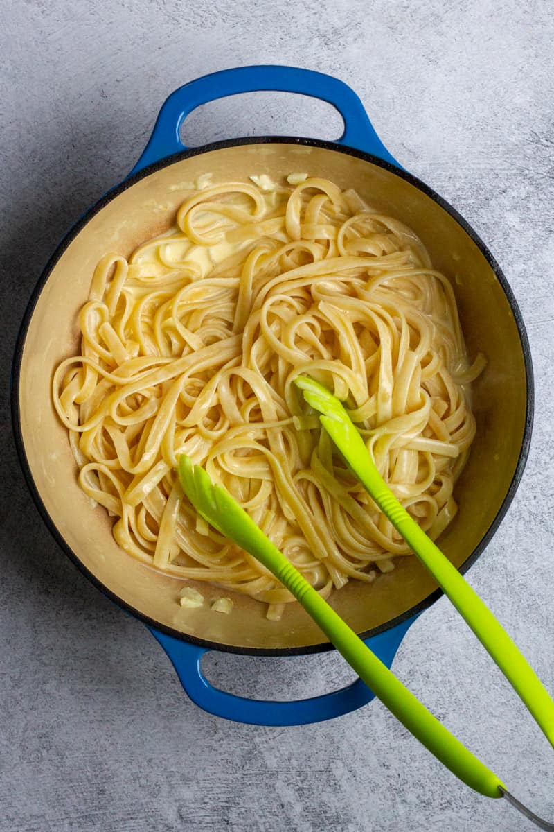 Toss Fettuccine in Cheese Sauce for Mushroom Alfredo.