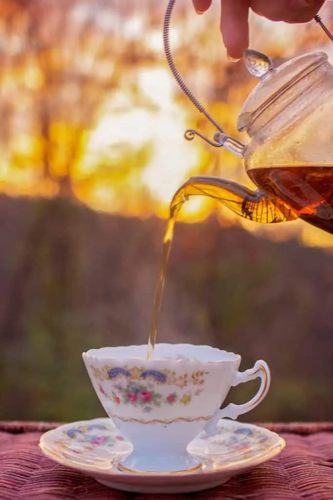 pouring tea from glass teapot.
