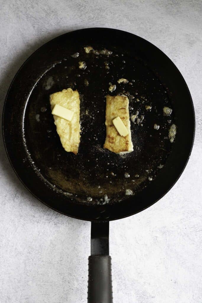 fish fillets in a pan with butter.