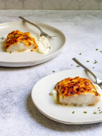 parmesan cod on serving plates.
