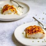 parmesan cod on serving plates.
