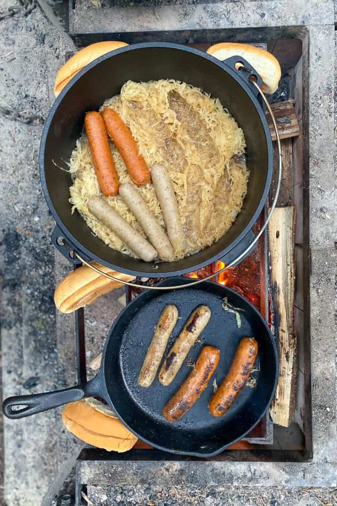 campfire bratwurst with sauerkraut and hot dog buns.