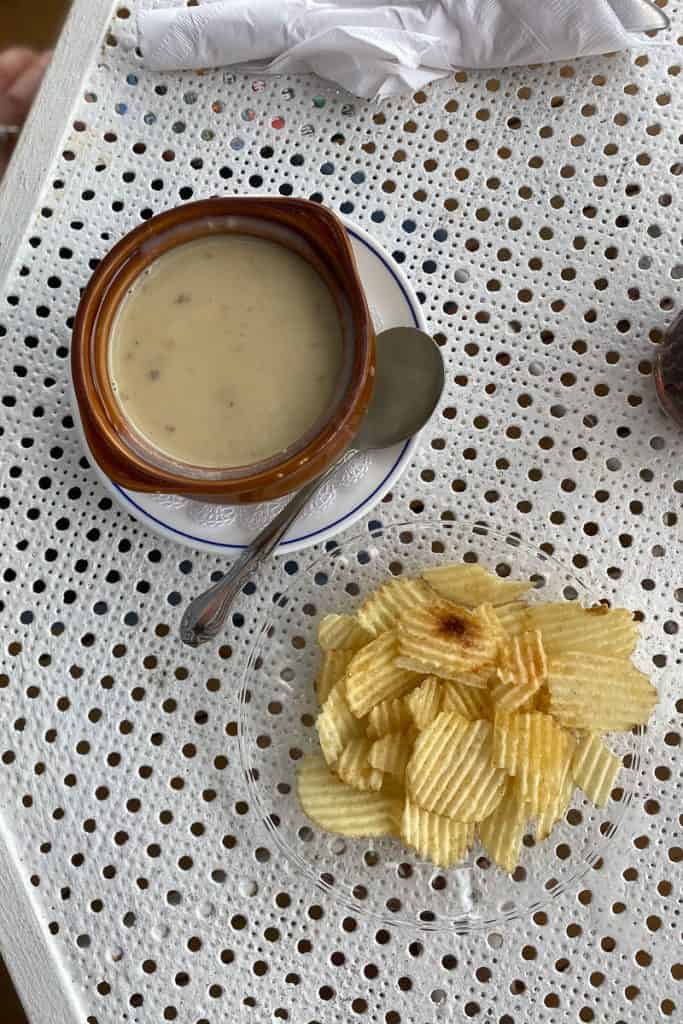 Bowl of soup and potato chips on a plate