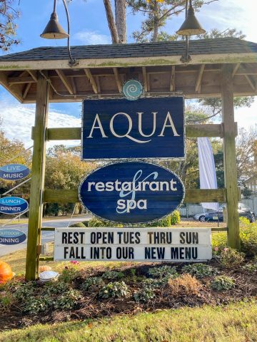 Aqua restaurant and spa roadside sign.