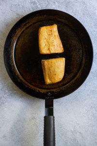 cooked yellowtail in a pan.
