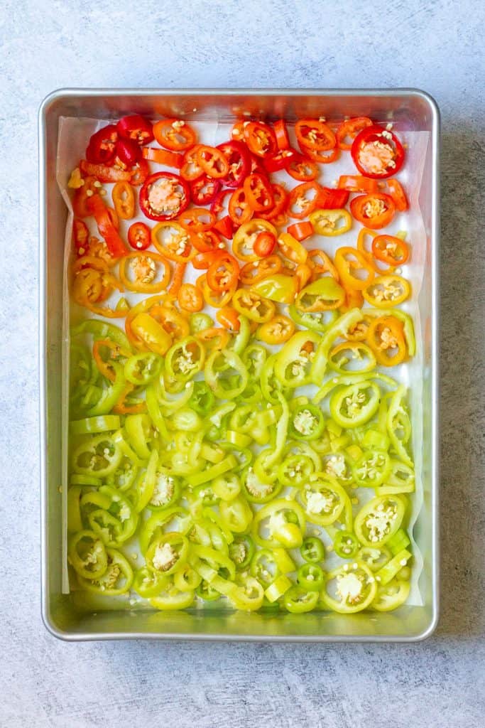 sliced peppers arranged on a baking sheet.