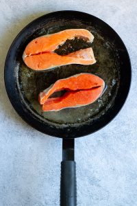 salmon steaks in a pan.