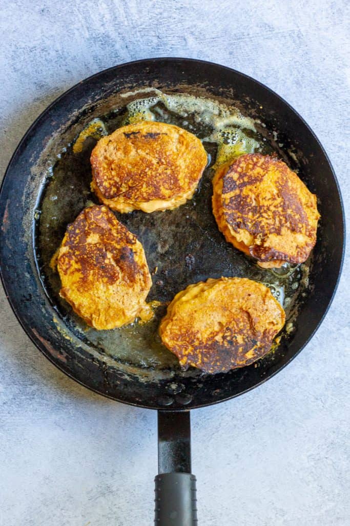 Pumpkin stuffed french toast in a skillet.
