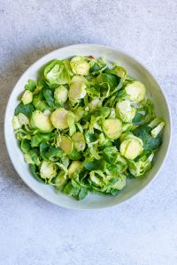 sliced brussels sprouts in a salad bowl.