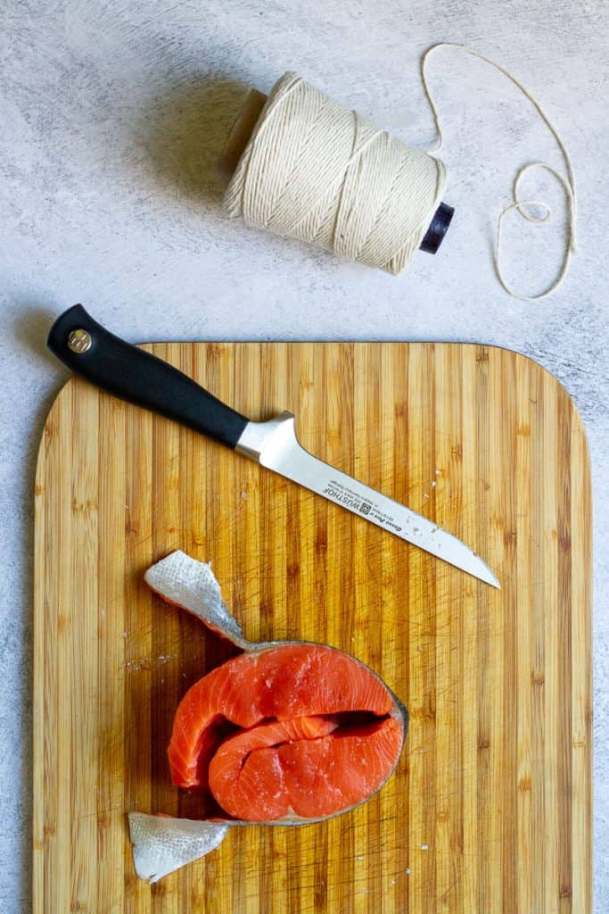 salmon steak roll on a cutting board.