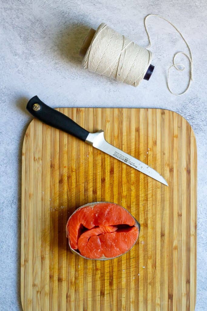 salmon steak roll on a cutting board.