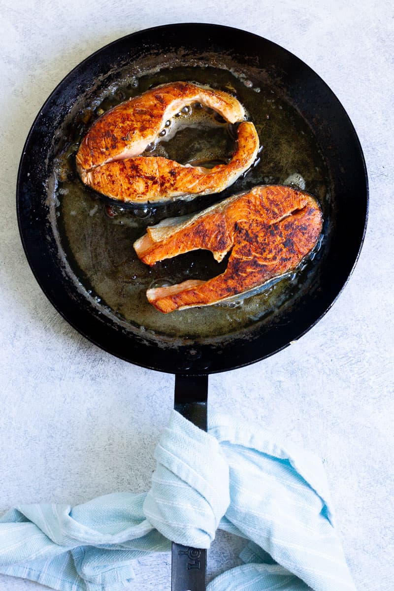 salmon steaks in a pan.