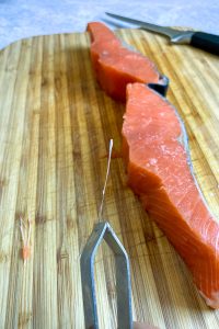 Pin bone from salmon steak.
