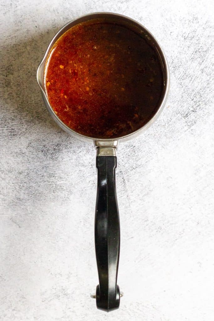 sweet and sour sauce in a saucepan.