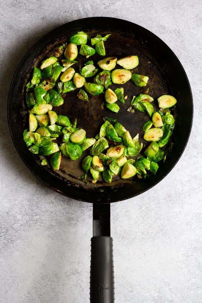 cooked brussels sprouts in pan.