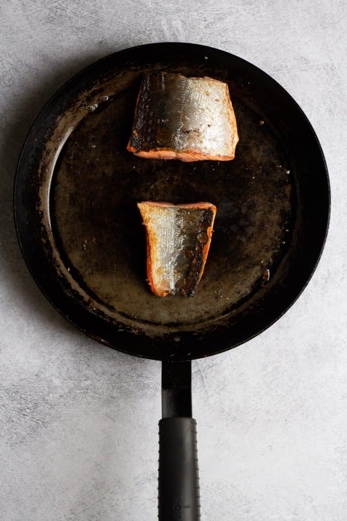 salmon skin-side up in pan.