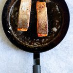 trout flipped over in the pan, skin-side up.