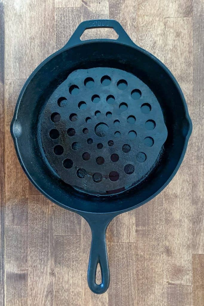 cast iron pan with meat trivet.