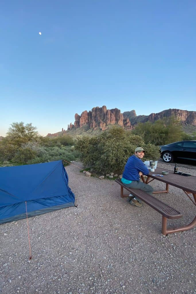 Campsite with tent and man at picnic table at Lost Dutchman State Park