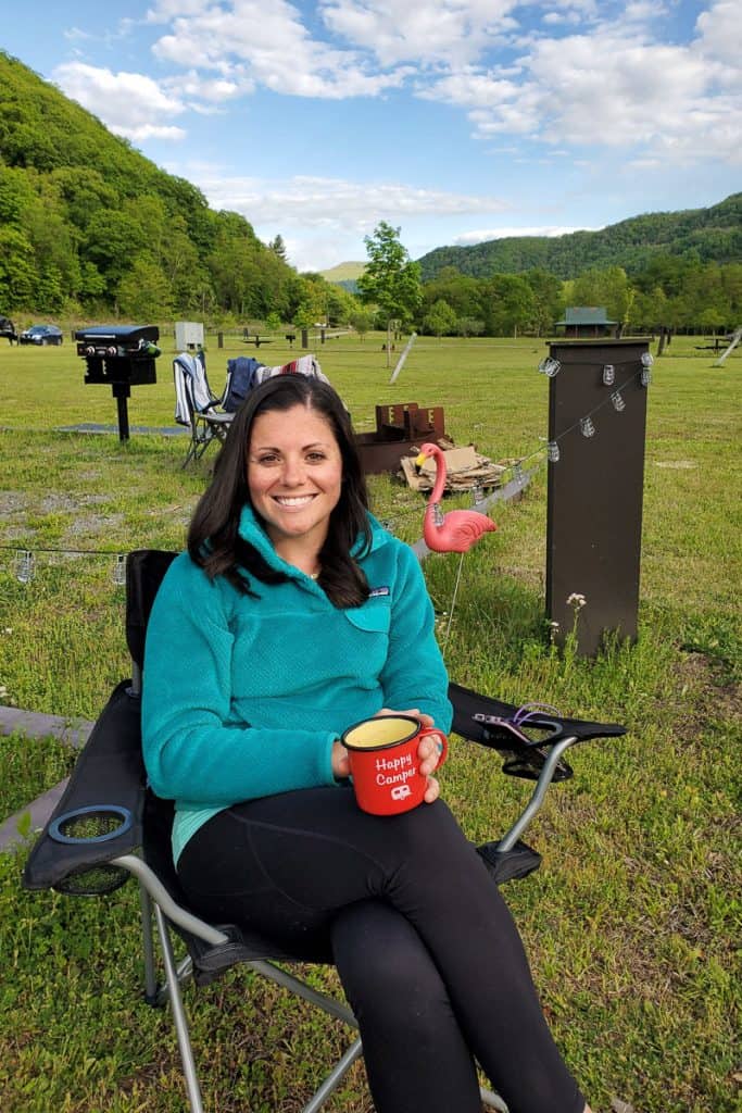woman seated in camping chair at free camping site in New River Gorge