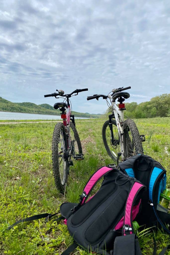 Bikes and backpacks, with lake in background.