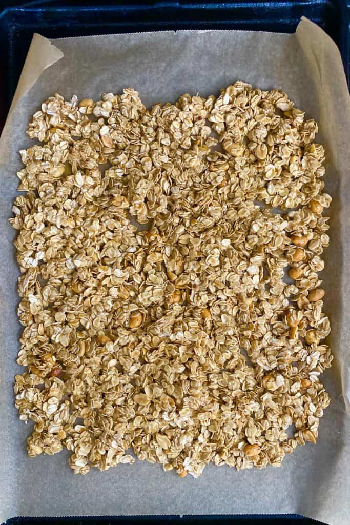Granola Mixture Spread onto Baking Sheet with Wax Paper.